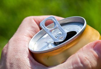 Can of beer in a man's hand