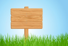 Wooden Sign On Green Grass