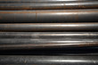 Steel pipes bundled together in a warehouse.