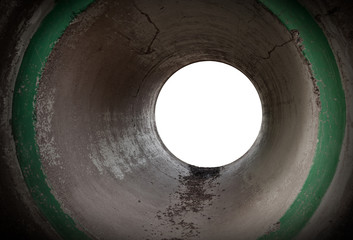 Glowing end of an empty round concrete tunnel interior