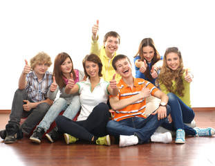 Wall Mural - A group of young and happy teenagers sitting together