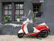 Trendy moped against old house. Fribourg, Switzerland