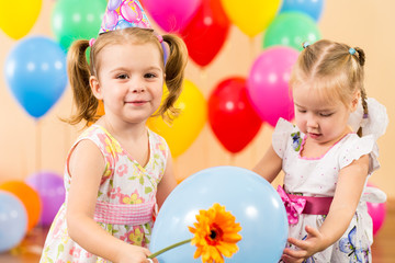 pretty children with colorful balloons and gifts on birthday par