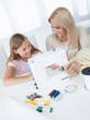 © Andrey Popov - Beautiful Young Girl Sewing With Her Mother