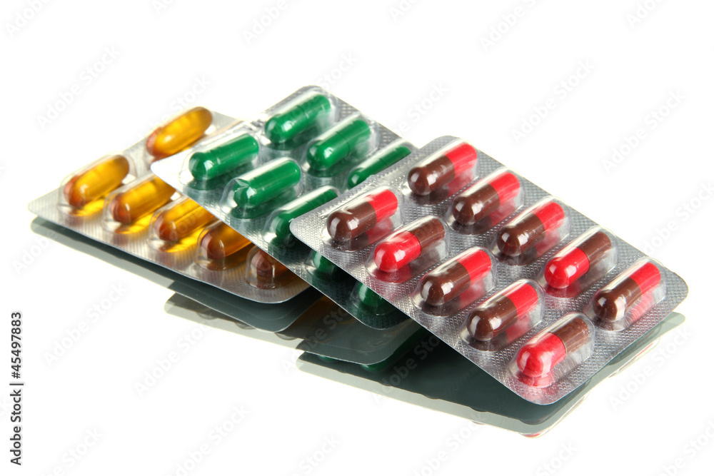 Capsules packed in blisters, isolated on white