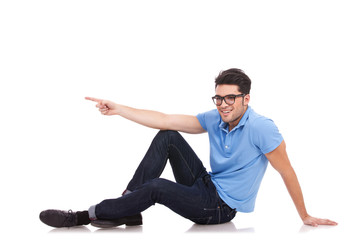 Poster - casual man sitting pointing to a side