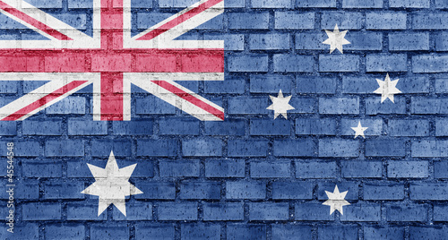 Board z aluminiowym obramowaniem Flaga Australii na ścianie z cegły