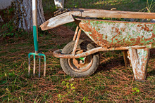 Gardening Tools In Old Rusty Wheelbarrow
