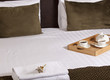 © ercan senkaya - Tray with coffee on a bed in a hotel room