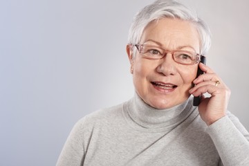 old lady on mobile phone smiling