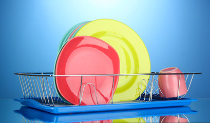 Color plates in rack on blue background