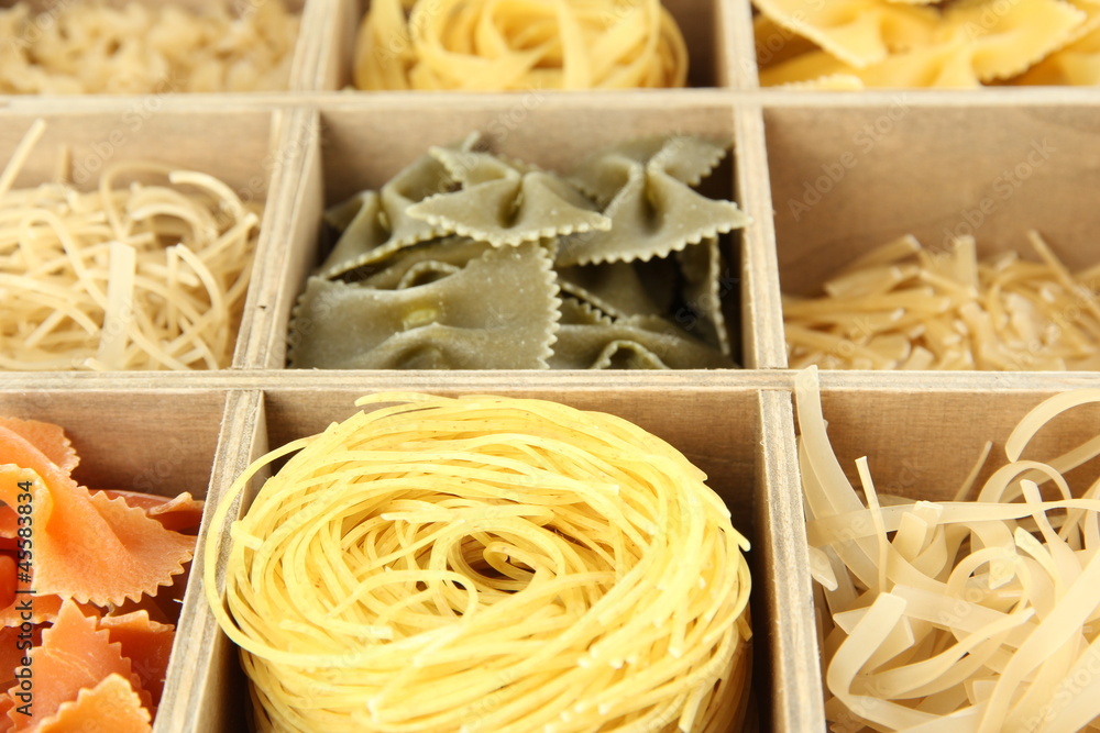 Nine types of pasta in wooden box sections close-up