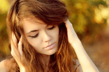 Canvas Print - Young woman outdoors portrait. Soft sunny colors.