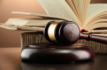 Wall Mural - wooden gavel and books on wooden table,on brown background