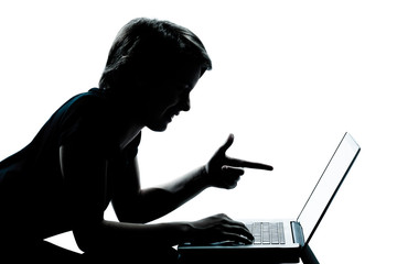 one young teenager boy or girl silhouette computer computing lap