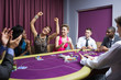 © WavebreakmediaMicro - People cheering at poker table