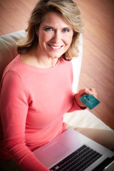 Poster - Woman with laptop and a credit card.