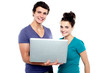 © stockyimages - Charming teen couple holding a laptop
