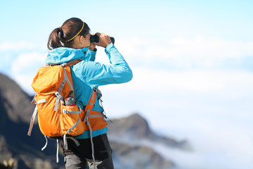 Wall Mural - Hiker looking in binoculars