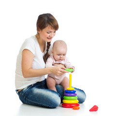 baby girl and mother playing together with construction set toy