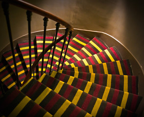 Wall Mural - Footsteps with carpet on spiral ladder in a small French hotel