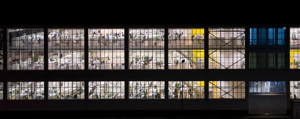 Wall with windows of an empty office building at night