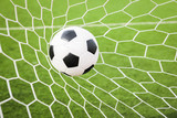Fototapeta Młodzieżowe - football in the goal net
