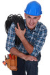 © auremar - Tradesman carrying a cable coiled around his shoulder
