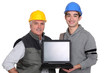 © auremar - Tradesmen holding a laptop