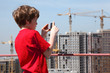 © Pavel Losevsky - boy with camera photo construction yard from roof of building
