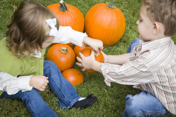 Cute Young Brother and Sister At the Pumpkin Patch