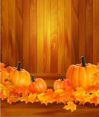 Poster - Pumpkins on wooden background with leaves.
