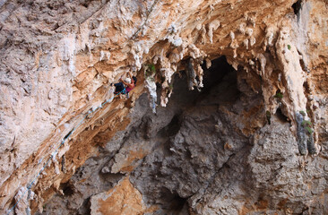 Wall Mural - Female rock climber on a cliff face