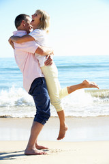 Wall Mural - Senior Couple Enjoying Romantic Beach Holiday