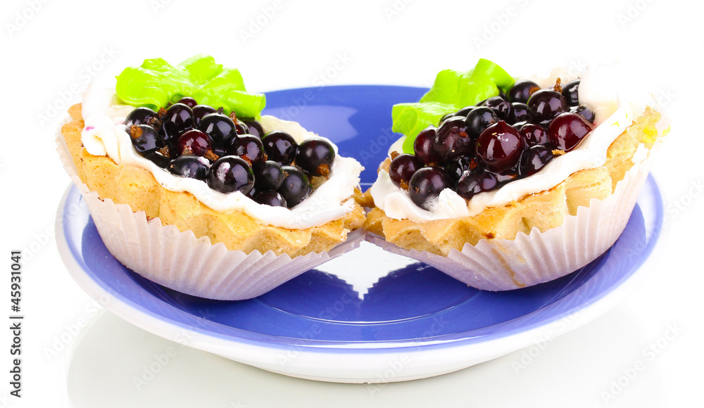sweet cakes with berries on saucer isolated on white
