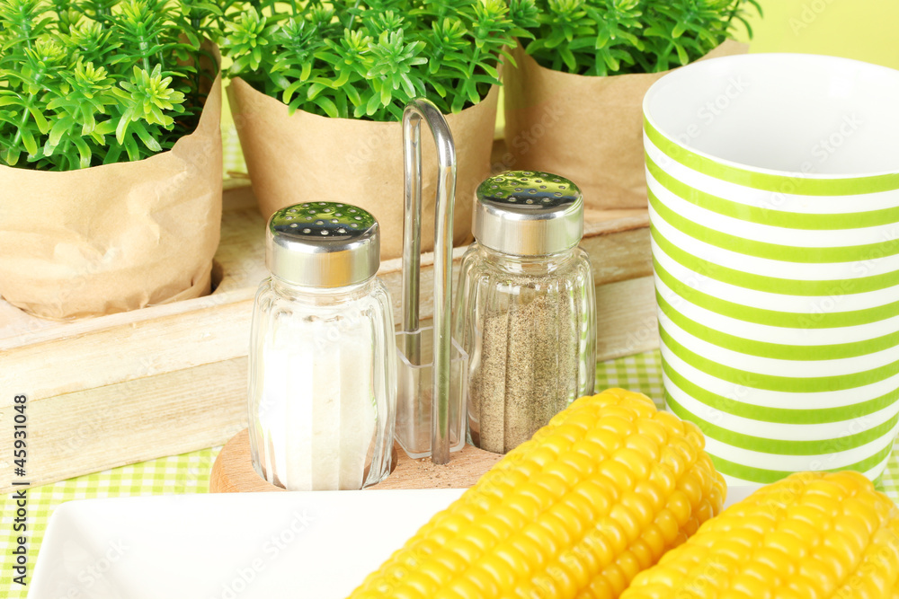 boiled corn and flowers on a green background