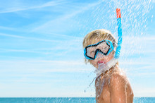 Boy With Diving Mask Taking A Shower At The Beach