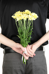 Wall Mural - man holding flowers close-up