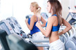 © mr.markin - Two young women run on machine in the gym