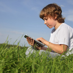 Wall Mural - Boy with tablet pc outdoors