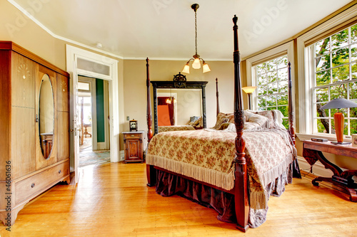 Fotografie, Obraz Large historical Inn room interior - bedroom with antique bed.
