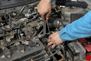 Wall Mural - Car servicing, worker hands and tool, gasoline engine