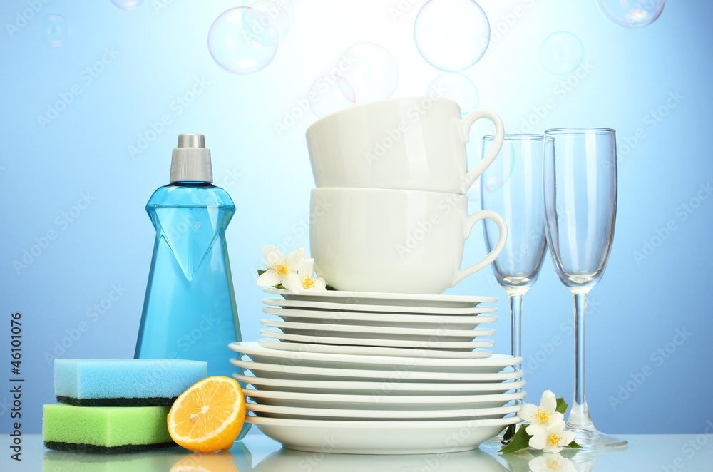 empty clean plates, glasses and cups with dishwashing liquid,