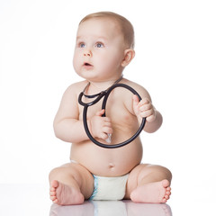 Wall Mural - Sweet baby with stethoscope on a white background. Adorable baby