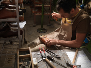 adult man working in a shoe factory