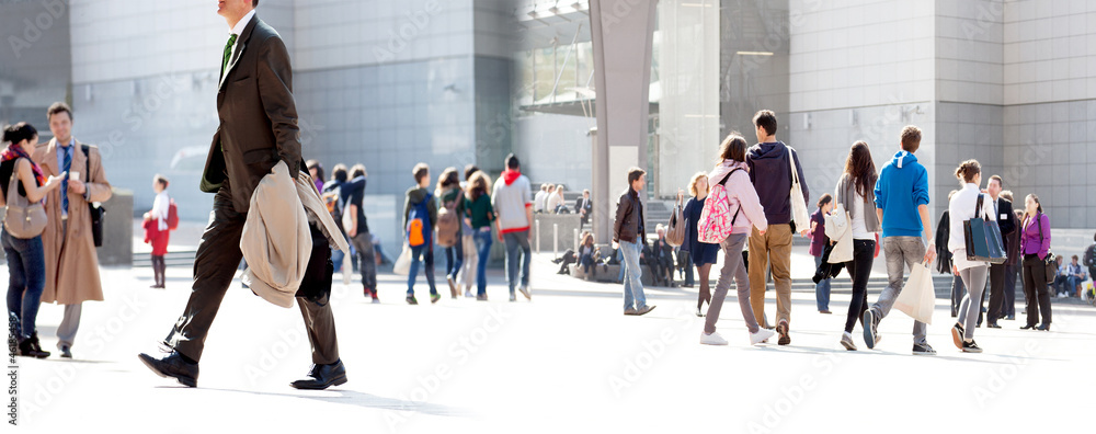 People walking against a light background. - obrazy, fototapety, plakaty 