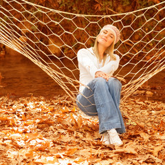 Wall Mural - Cute female in sitting in hammock