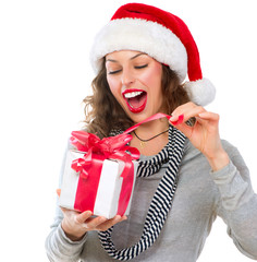 Wall Mural - Beautiful Young Woman Opening Christmas Gift Box. Surprised Girl