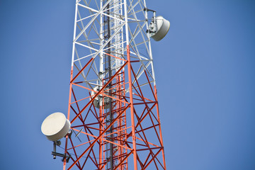 Wall Mural - Mobile tower communication antennas with blue sky background 