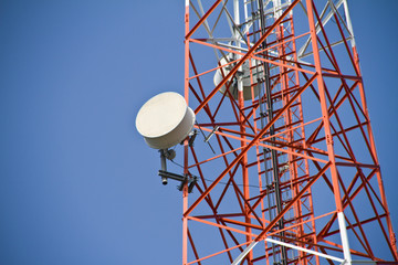 Wall Mural - Mobile tower communication antennas with blue sky background